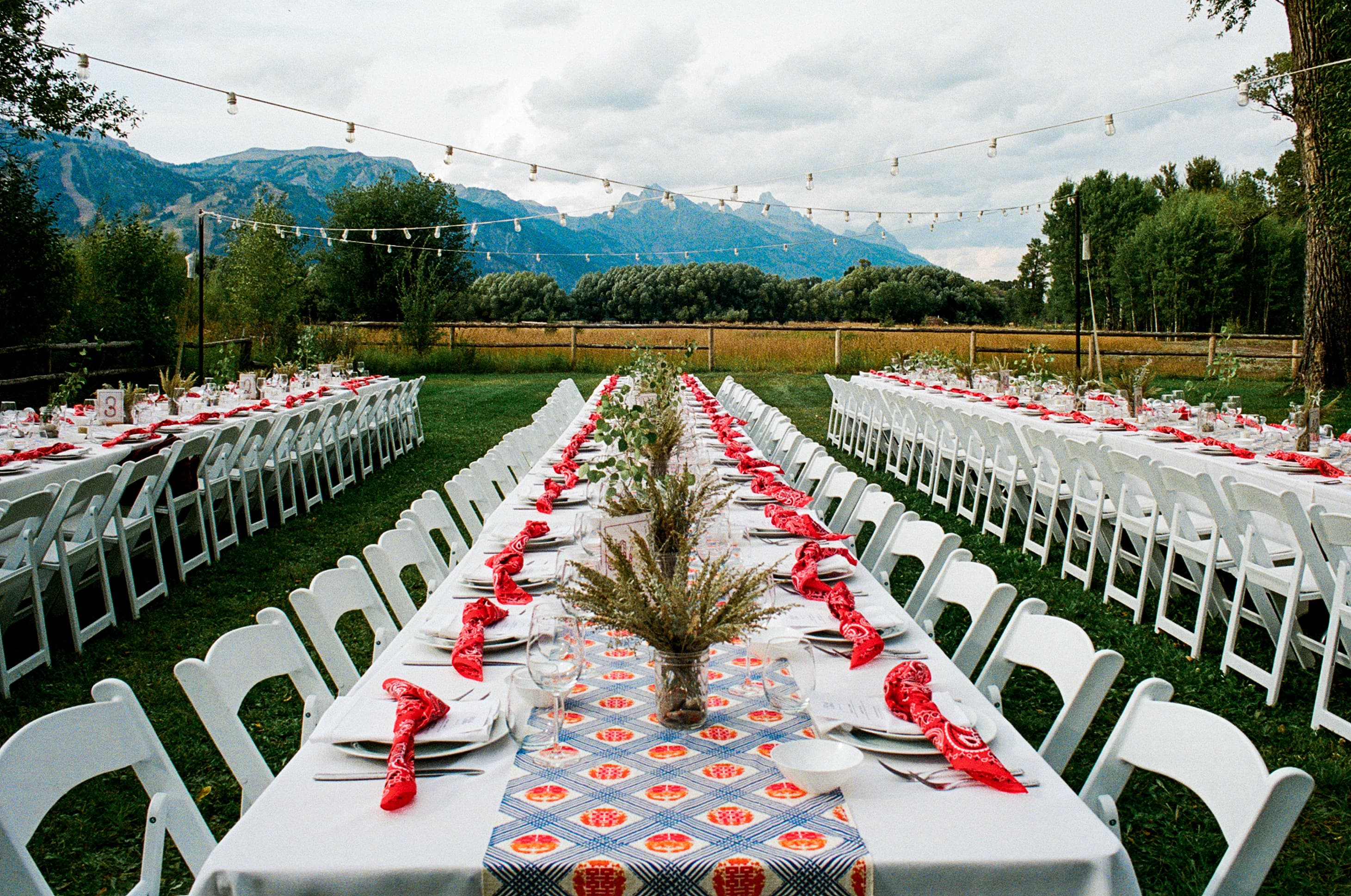 Elegant outdoor dining setup with mountain views and string lights